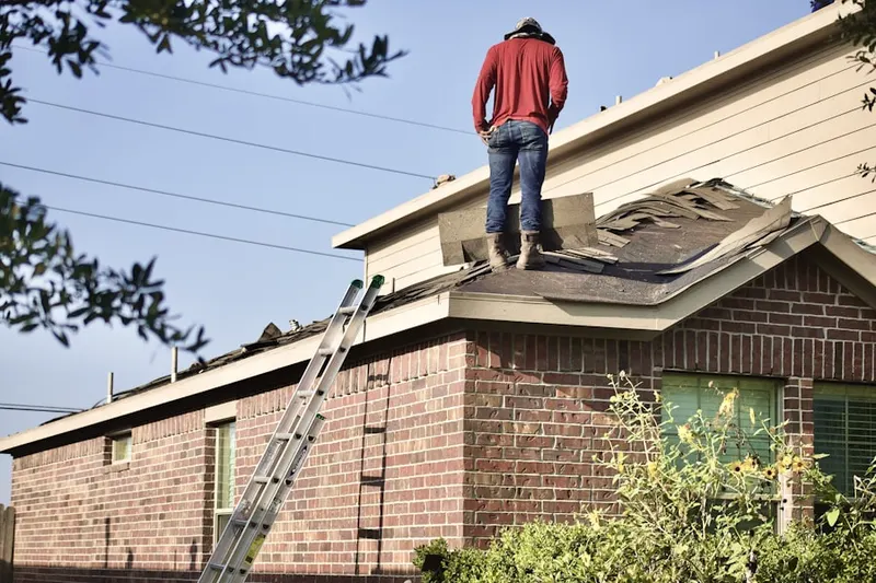 Professional roofer working on a residential roof in Lake Geneva